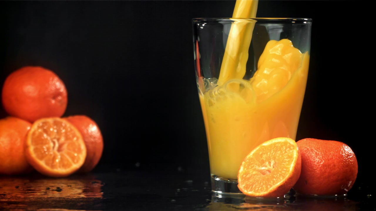 Refreshing Orange Juice Poured into Glass with Fresh Citrus Fruits