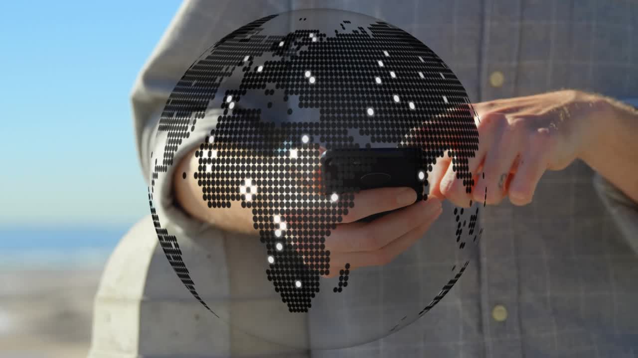 Man tapping smartphone on balcony overlooking beach activating rotating globe technology demo