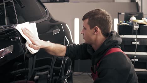 Finishing-off-cleaning-process-of-a-black-new-car.