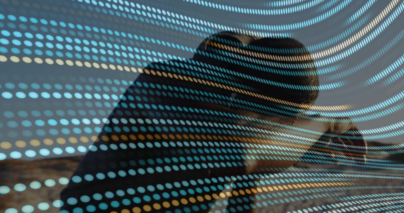 Vertical video: Man leaning checking device as blue-yellow dots overlay sweeping across tech scene