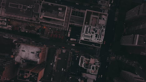 AERIAL:-Overhead-View-of-Skyscraper-Building-Rooftops-in-Manhattan-New-York-City-at-Dawn-after-Sunset