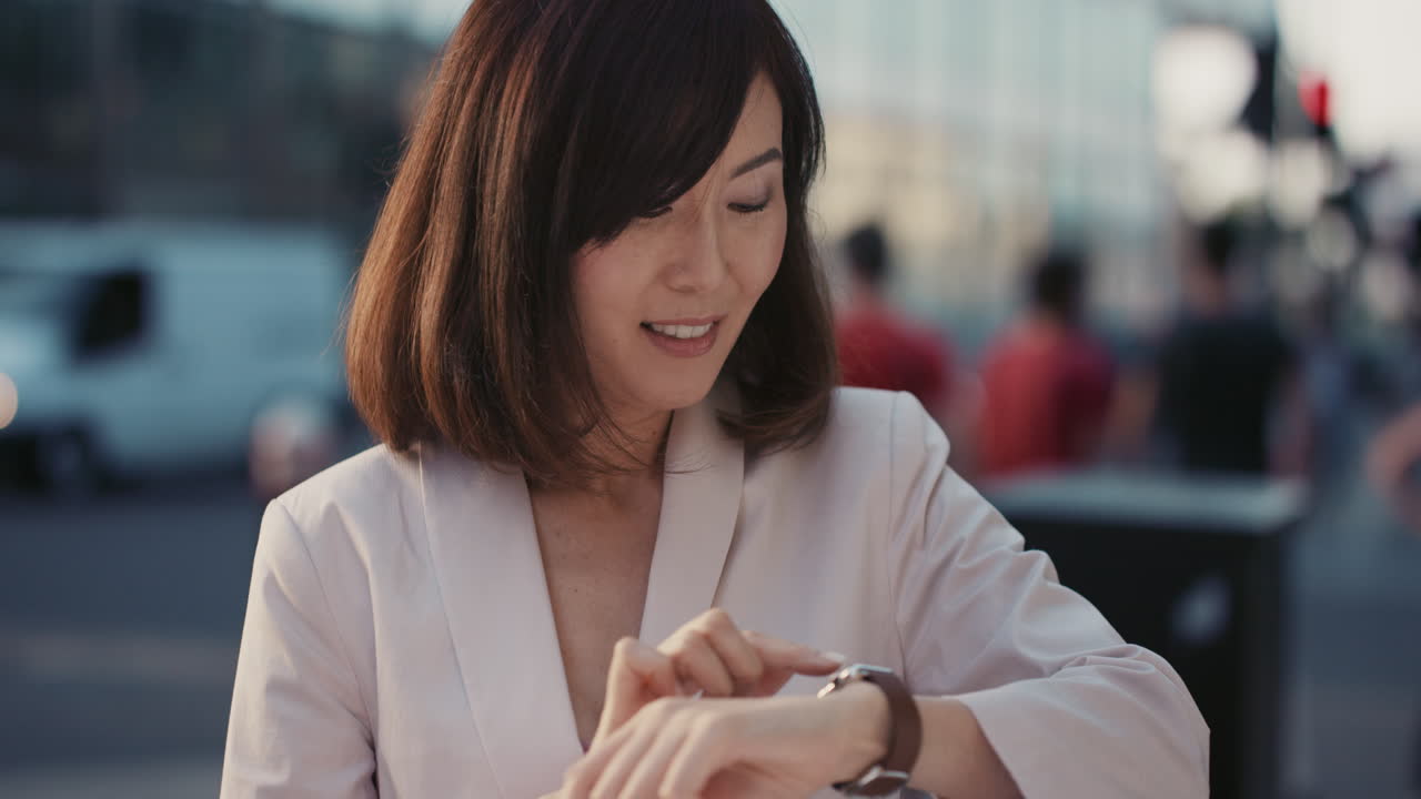 Slow Motion Portrait of happy beautiful Japanese woman using smart watch