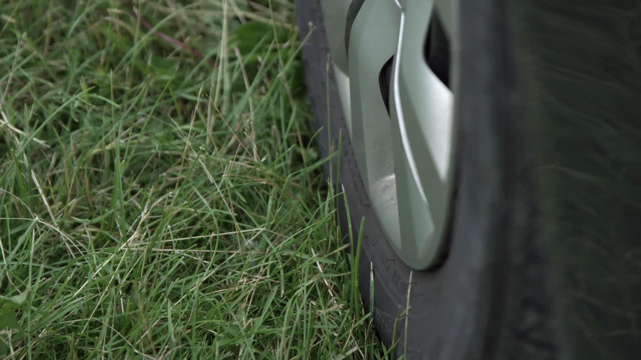 Close Up Of A Car Wheel Parked On Green Grass