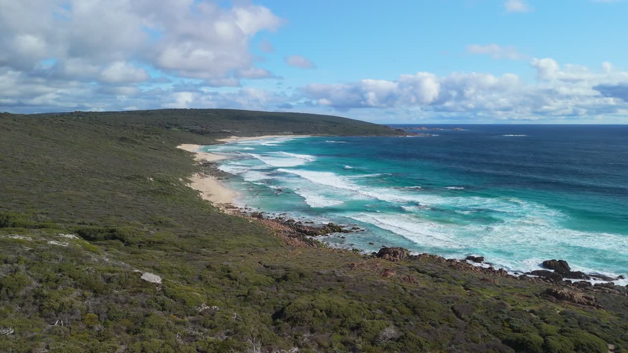 Drone slowly going over forest to reveal sandy beach in Western Australia