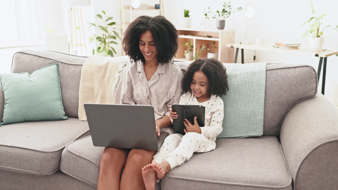 Laptop, tablet and woman with kid on sofa together