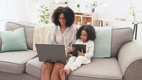 Laptop,-tablet-and-woman-with-kid-on-sofa-together