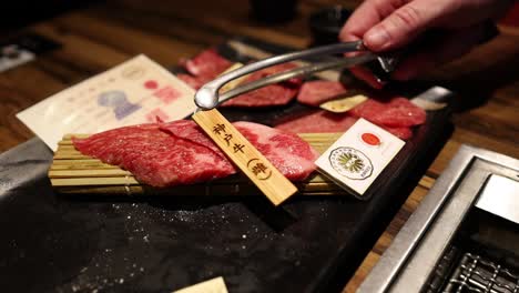 chef precisely cuts high-quality beef on board