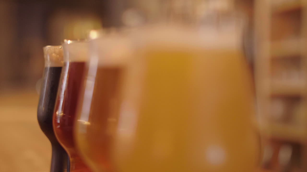 Changing focus on glasses of artisanal beer on bar counter, Montpellier France