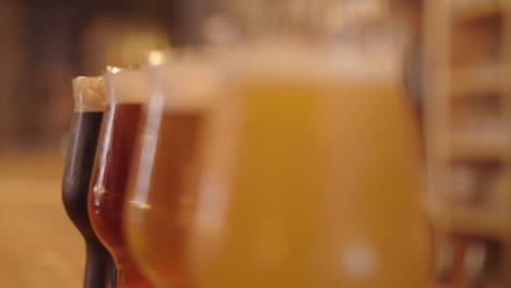 changing focus on glasses of artisanal beer on bar counter, montpellier france