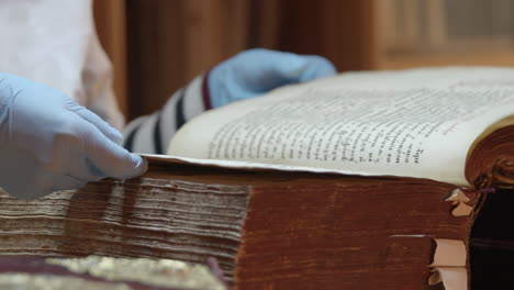 carefully handling an ancient book