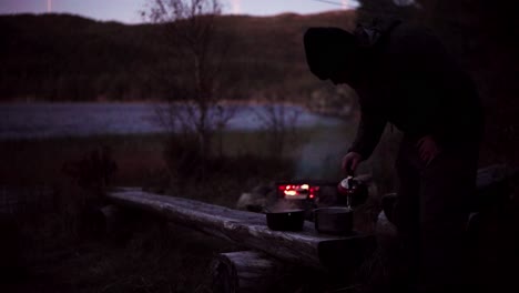 camper pouring hot water into food