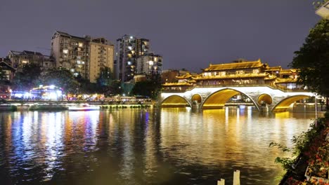 Erstaunlicher-Zeitraffer,-Der-Eine-Lebendige-Nachtansicht-Der-Anshun-Brücke-Mit-Vorbeifahrenden-Booten,-Wunderschöner-Beleuchtung-Und-Einer-Barstraße-Im-Zentrum-Von-Chengdu,-China,-Zeigt