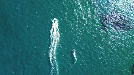 Jet-ski-sailing-at-seascape-in-the-south-coast-of-spain-aerial-drone-view