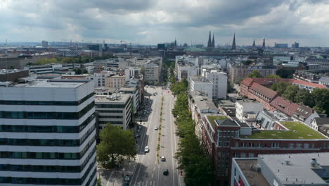 Ascending-and-tilt-down-footage-of-wide-multilane-road-in-urban-neighbourhood.-Free-and-Hanseatic-City-of-Hamburg,-Germany