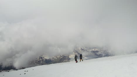 hikers on a snowy mountain summit