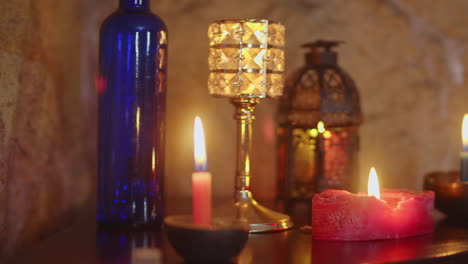 dynamic pan shot of a relaxing candle lit environment with natural stone wall and a pleasing shallow depth of field