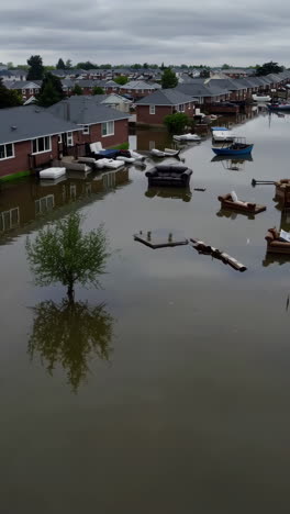 aftermath of a flood: homes and furniture submerged in a residential area