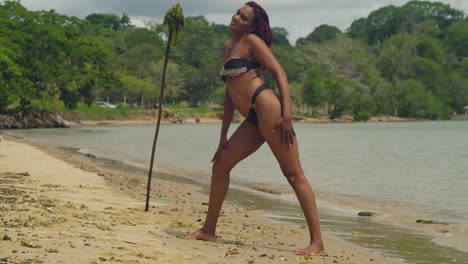 a young girl in a bikini delights in the beach on trinidad island, located in the caribbean