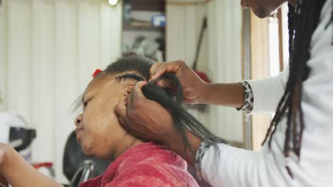 african man adding hair extensions