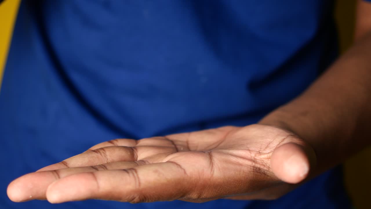 Person holding a pill in their hand