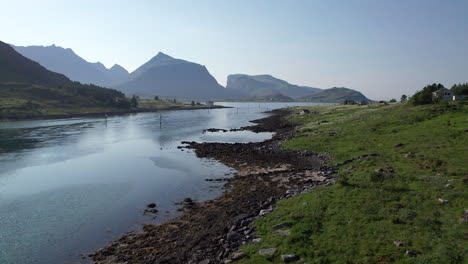 Low-aerial-drone-shot-of-Norwegian-shoreline-during-summer-in-Lofoten