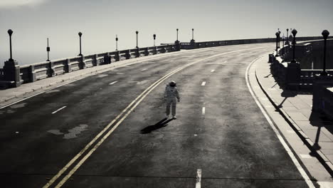 astronaut walks in the middle of a road