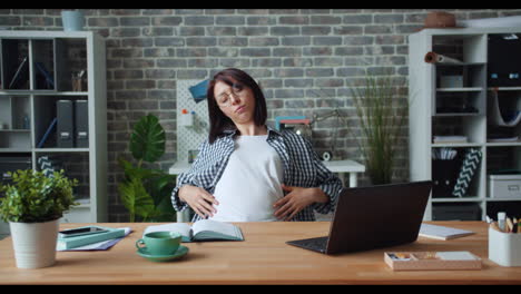 woman stretching in office
