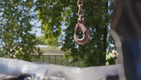 hanging rusted iron clad scrapyard hook