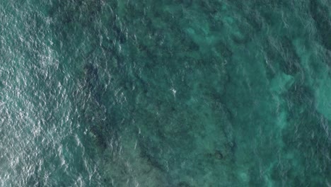 aerial view from above of the turquoise green water of the pacific ocean creating a beautiful texture