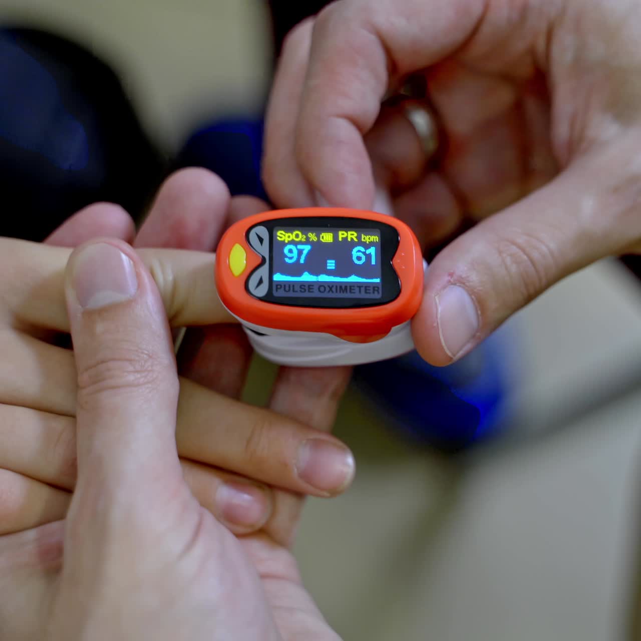 Special device for measuring heart rate. Doctor puts electrical appliance on boys finger. Selective focus