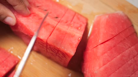 cutting fresh watermelon into slices