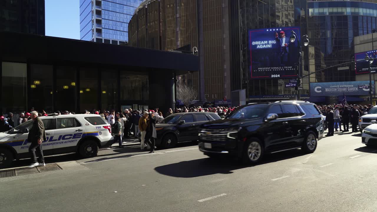 Trump supporters gather in front of Madison Square Garden, the sunlight casting a golden glow over the excited crowd