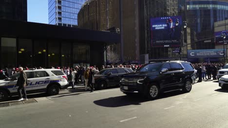 trump supporters gather in front of madison square garden, the sunlight casting a golden glow over the excited crowd