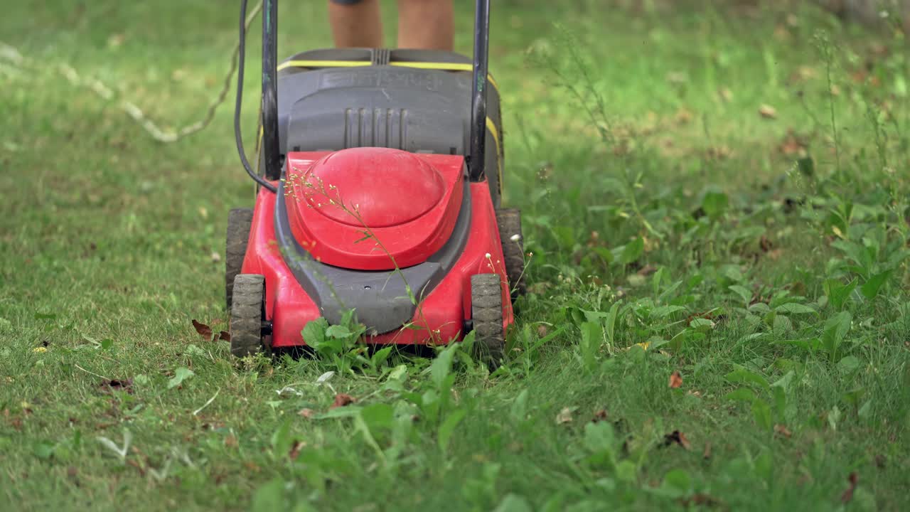 Lawn mower in the garden. Lawn mower machine on green lawn