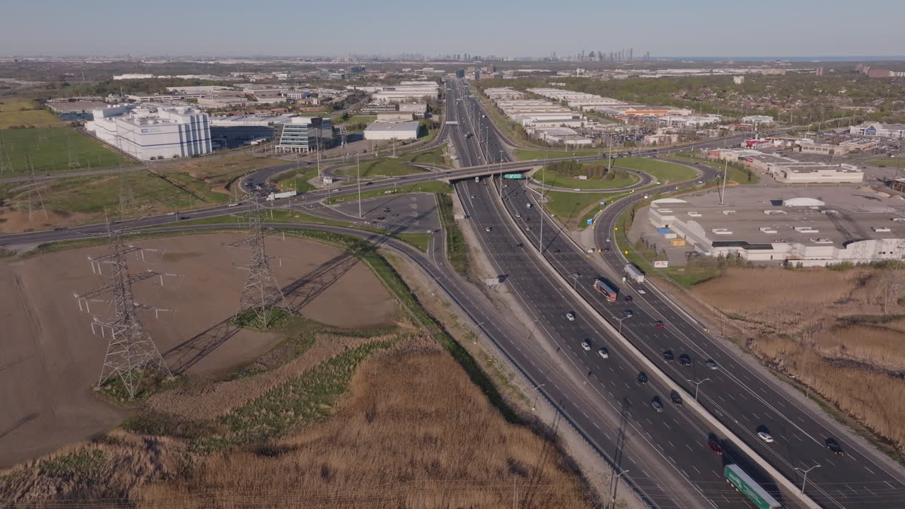 Highway 401 in mississauga with power lines and surrounding industrial buildings, aerial view