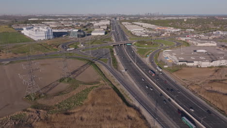 highway 401 in mississauga with power lines and surrounding industrial buildings, aerial view
