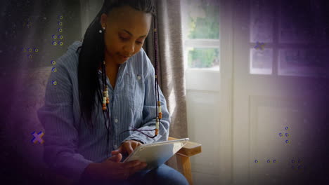 woman using tablet in home interior, with animated data graphs illustrating technology trends