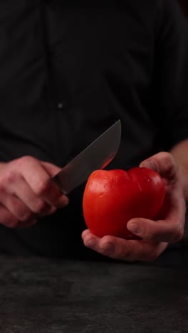 chef cutting a red bell pepper