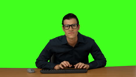 Businessman-typing-at-his-desk