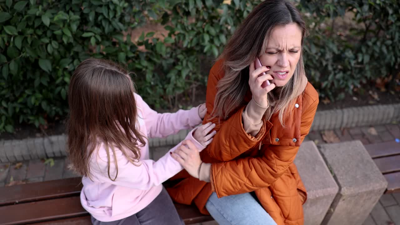 Concerned Mother on Phone with Daughter in Park
