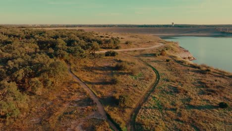 walking trails along the shoreline of lake georgetown at overlook park in georgetown, texas aerial drone orbit