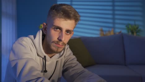 Close-up-portrait-of-thoughtful-and-sad-young-man-at-home.