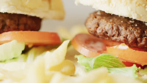 video close up of two hamburgers with salad in burger buns