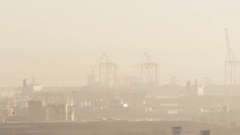 vista general del paisaje urbano con múltiples edificios y astilleros cubiertos de niebla