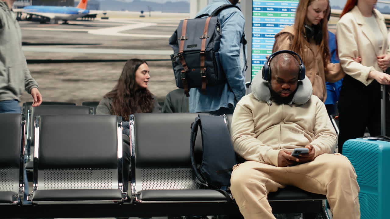 Tourists in airport lounge carrying trolleys, traveling by plane during trip