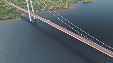 above view of a white trailer truck crossing hogakustenbron bridge in sweden