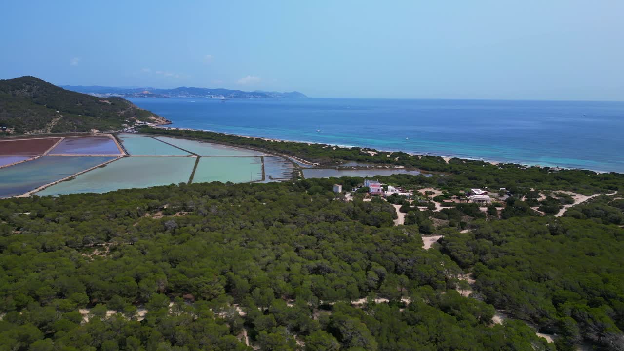 colorful salt flats of Ibiza with the Mediterranean vegetation in the foreground. Amazing aerial view flight panorama overview drone