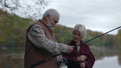 grandfather and grandchild fishing together in autumn