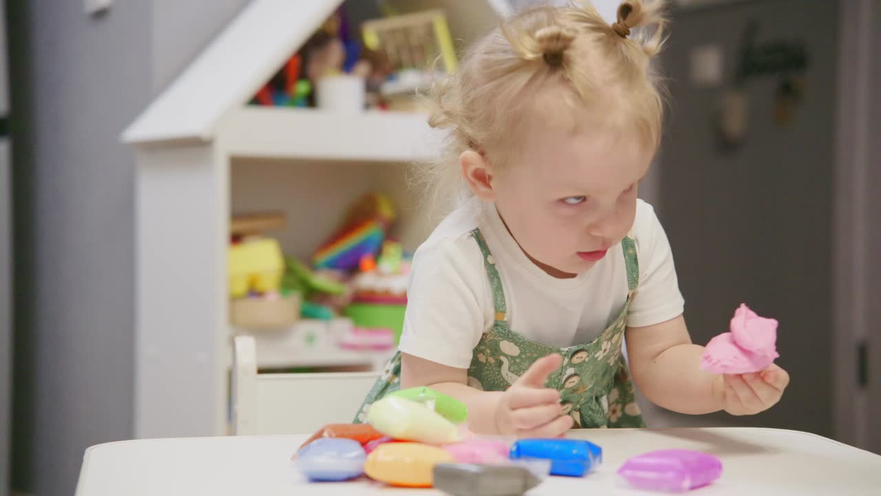 Cute Toddler Girl Playing with Colorful Playdough at Home
