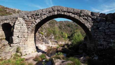 flying over ancient stone bridge over beautiful river